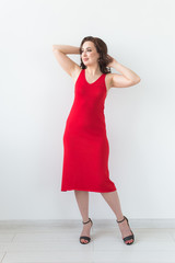 Girl posing on a white room. Fashion style studio portrait. Elegant fashionable woman.