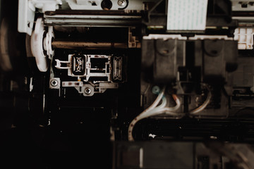 Close up interior of printer showing print heads in inkjet systems. Professional printer maintenance concept. Technical support in office hardware Continuous repair of the ink system. 