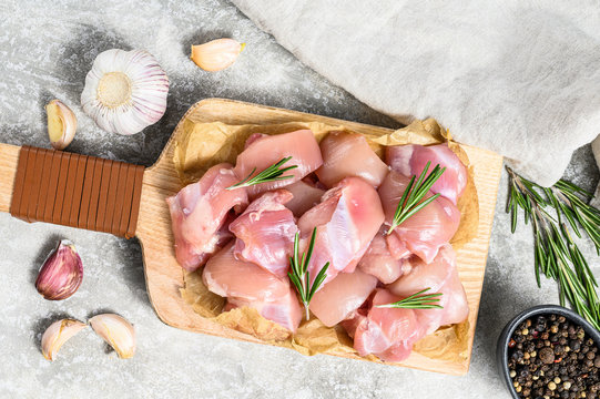 Raw Chicken Fillet Cut Into Cubes With Spices. Gray Background. Top View