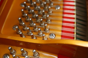 Naklejka premium Music playing from the ancient ruined piano . Hammers in abandoned piano striking strings tuned to produce the note when a piano key is pressed.