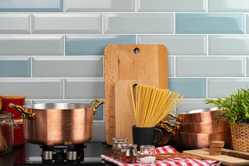 Metal pot on a gas stove burner at home kitchen close up