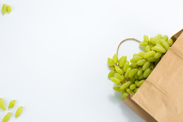 Grapes paper bag of craft paper on white background. Free space for your text. Top view.
