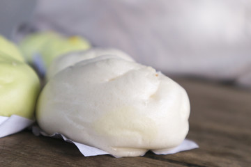 Chinese steamed buns on a wooden floor