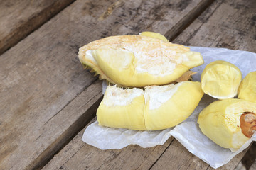 Durian riped and fresh with yellow colour on wooden table.
