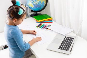 Child hand draws a color pencil. Distance Learning