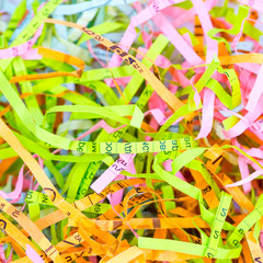 Detailed close up background of colorful shredded paper. Selective focus