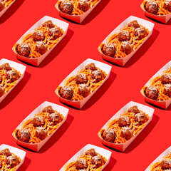 Creative seamless pattern of spaghetti and meatballs with tomato sauce in takeaway packaging box on red background in pop-art style.Restaurant food delivery concept.Photography collage