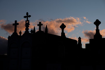 Silhouette of a cemetery at sunset