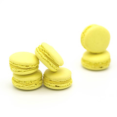 Yellow lemon macarons on a white background
