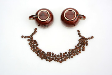 Smiley face made from coffee cups and coffee beans. Happy face with coffee.