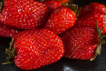 Directly above view of strawberry on black stone background.