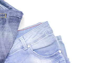 Blue jeans is on a white background. Clothes for donations. Fragments of clothing.