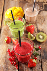 smoothie with fresh fruits on wood background