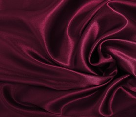 Smooth elegant pink silk or satin luxury cloth texture as abstract background. Luxurious background design