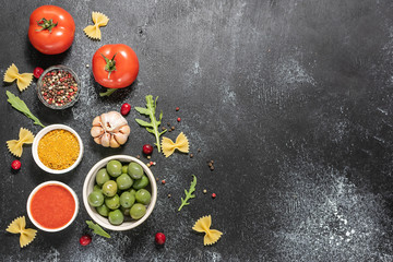 Fresh aromatic ingredients for cooking pasta on black background with copy space for your text.