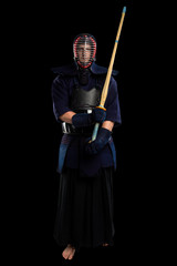 male in tradition kendo armor with shinai (bamboo sword). shot in studio. Isolated with clipping path on black background