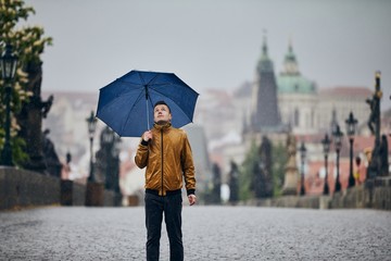 Man with umbrella in heavy rain