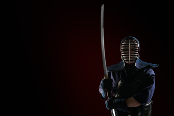 Male in tradition kendo armor with Samurai sword katana. shot in studio. Isolated on black...