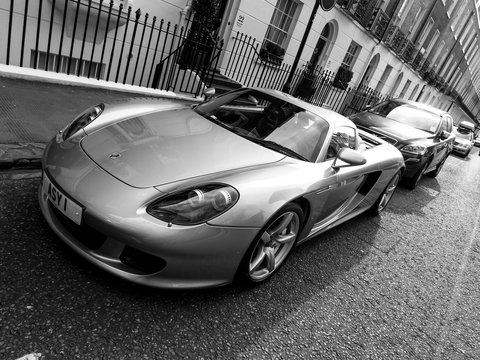 LONDON, UK - CIRCA MARCH 2013: A Porsche Carrera GT parked in the street. The Carrera GT is a mid-engined sportscar produced between 2004 and 2007. Black and white photography.