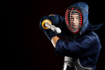 male in tradition kendo armor with shinai (bamboo sword). shot in studio. Isolated with clipping path on black background