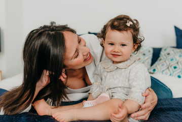 young pretty mother plays with her daughter
