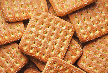 Shortbread brown homemade shortbread from the oven. Cookies are square in shape, flat with a hole, yellow, beige and brown.