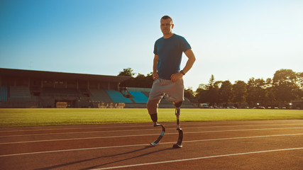 Athletic Disabled Fit Man with Prosthetic Running Blades is Posing During a Training on an Outdoor...