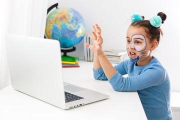 Little actress, little girl studying theater on laptop online