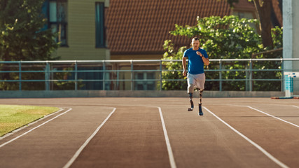 Fototapeta premium Athletic Disabled Fit Man with Prosthetic Running Blades is Training on a Outdoors Stadium on a Sunny Afternoon. Amputee Runner Jogging on a Stadium Track. Motivational Sports Shot.
