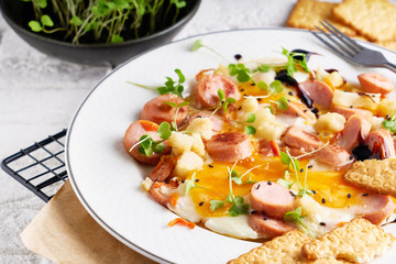 Healthy homemade breakfast. eggs with sausages , spices ,arugula served in a plate