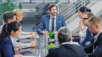 In the Modern Corporate Office Meeting Room: Diverse Group of Businesspeople, Lawyers, Executives and Members of the Board of Directors Talking, Negotiating and Working on a Winning Strategy. 