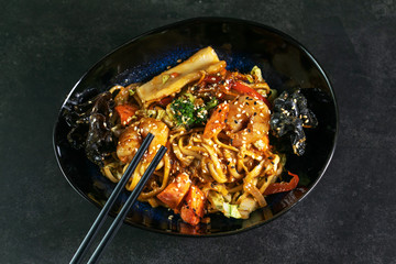 Asian noodles with seafood on plate
