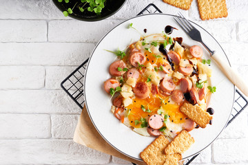 Healthy homemade breakfast. eggs with sausages , spices ,arugula served in a plate