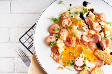 Healthy homemade breakfast. eggs with sausages , spices ,arugula served in a plate