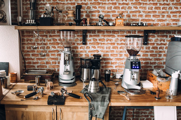 Accessories and items for coffee on a background of a brick wall. School barista. Equipment for cafes.