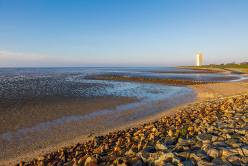 The colors of the sunrise over the Wadden Sea at low tide