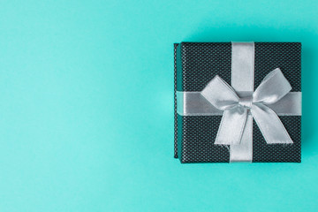 Gift box on a blue background with copyspace. Top view.