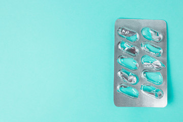 Used blister without tablets on a blue background with copyspace. Top view.