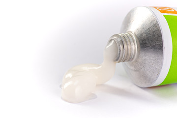 ointment or cream for external use is slightly squeezed out of a tube on a white background on a white background
