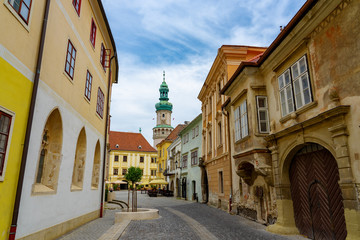 Fototapeta na wymiar narrow medieval street of Sopron with the fire watch tower in the background