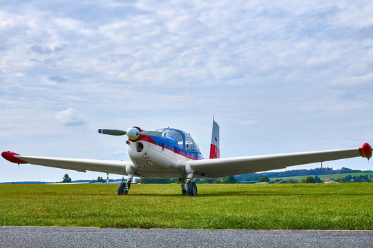 Zbraslavice / Czechia - 08/25/2019: Front view of Zlin Z-43 four-seat airplane standing on a grass runway.  Low-wing monoplane.