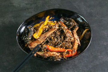 Asian noodles with meat on plate