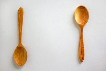 Two beautiful wooden spoons isolated on white background.