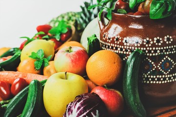 shapes and colors of fruit and vegetables arranged in a rustic composition