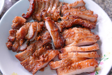 traditional Thai culture fried pork cuisine style or moo tod one of the most favorite famous street fast foods menu at thailand homemade
with hot spicy sauces on table wood dish sticky rice vegetable