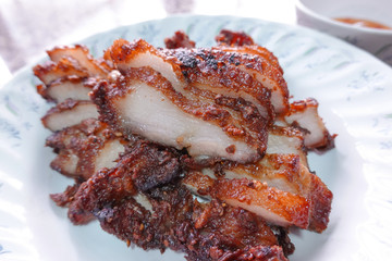 traditional Thai culture fried pork cuisine style or moo tod one of the most favorite famous street fast foods menu at thailand homemade
with hot spicy sauces on table wood dish sticky rice vegetable