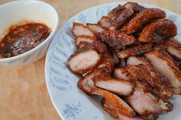traditional Thai culture fried pork cuisine style or moo tod one of the most favorite famous street fast foods menu at thailand homemade
with hot spicy sauces on table wood dish sticky rice vegetable