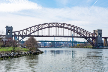 Fototapeta na wymiar The Hell Gate Bridge over the East River during Spring in Astoria Queens New York