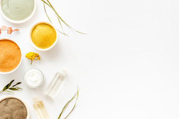 Various kinds of cosmetic clay on white desk top view copy space