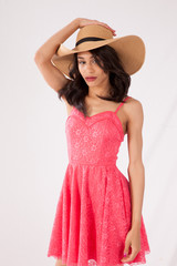 Pretty woman in a pink dress and straw hat